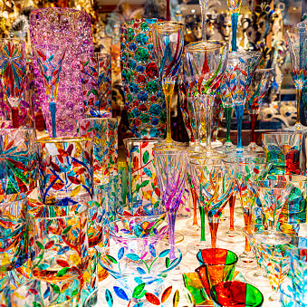 Close-up window display of colored glass fused artwork