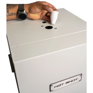 Arm/hand shown pulling the plug out of the wax burnout vent on the top of a Hot Shot HS-7GW Wax Burnout Kiln