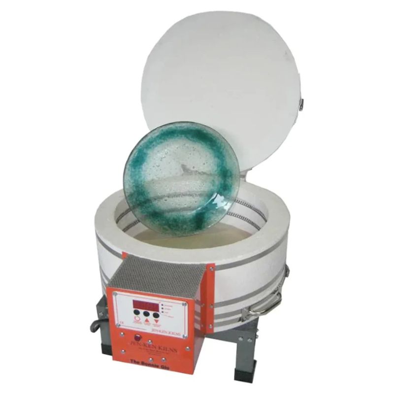 Top Down view of an opened, round-shaped AF3P Bonnie Glo Glass Kiln from Jen-Ken with a glass plate photoshopped into the chamber on a shelf leaving only the top 2 rows of side elements visible. Kiln is on a small metal stand with full visibility of the electrical box with the Orton AutoFire AF3C (AF4X) 3-Button controller.