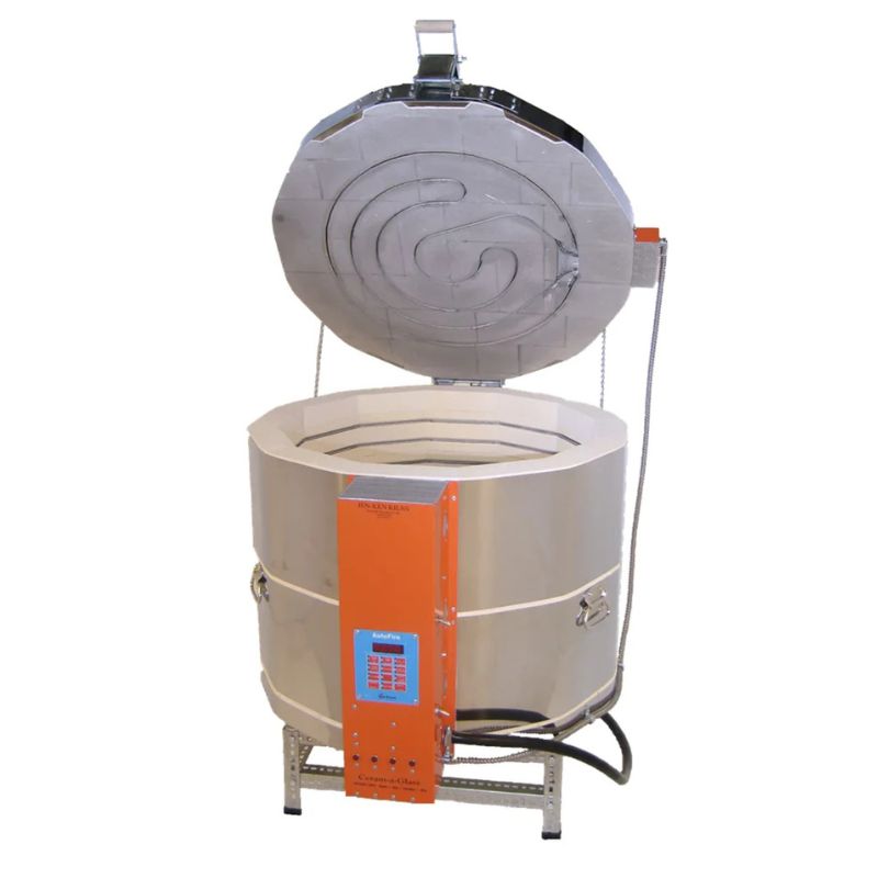 Slightly left-angled, opened, round-shaped AF Ceram-A-Glass 2822 ceramics and glass kiln from Jen-Ken, featuring 3" chamber brick and showing the electrical box with Orton AutoFire 4000 12-button controller while sitting on a short metal stand.