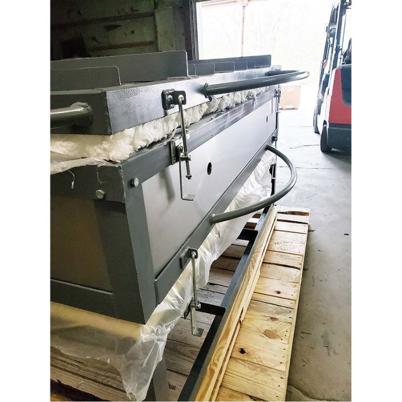 Side view of the front of large capacity Olympic Kilns GF15E glass fusing kiln featuring new handles, placed on top of a wooden pallet in a warehouse.