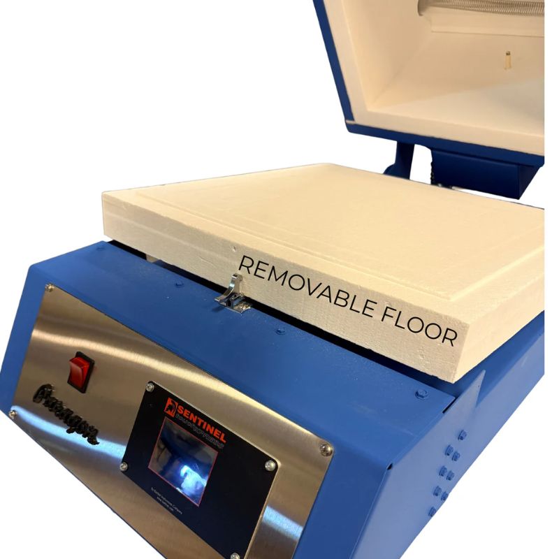 An open Paragon CSF12 Glass Fusing Kiln in Paragon Blue color, showing the Sentinel TouchXpress controller and featuring the removable floor in the kiln chamber.