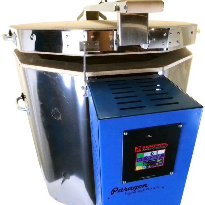 High-angle view of a slightly-opened, 10-sided round-shaped CT102322 ceramics and pottery kiln from Paragon with the Paragon Blue-colored electrical box with Sentinel TouchExpress digital controller right in front.
