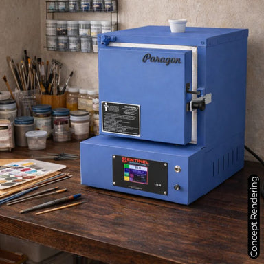 Closed E12T enameling & china painting kiln model from Paragon, set upon a desktop, painted in Paragon Blue color and showing the Sentinel TouchXpress controller beneath the door.