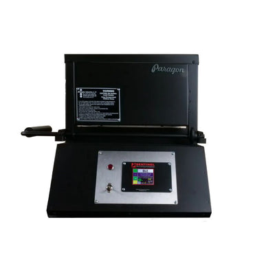 Straight-on view of closed KM14 Double Barrel Knife Making kiln from Paragon Kilns, in black color, with door handle on left and Sentinel TouchXpress controller beneath door.