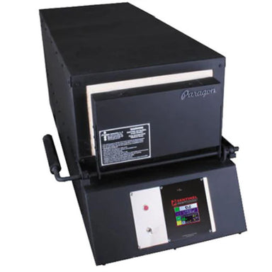 Closed KM18 Double Barrel Knife Making kiln from Paragon Kilns, in black color, with door handle on left and Sentinel TouchXpress controller beneath door.