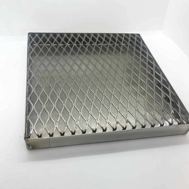 Meta wax burnout tray with raised expanded metal grate designed to catch melting wax during kiln burnout firing.