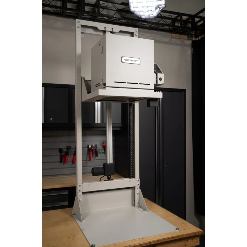 Front-angled view of closed HS-7GV Vitrigraph Glass kiln from Hot Shot  placed on and raised up on Hot Shot's motorized VitriLift Electric Vitrigraph Lift - all within a studio environment.