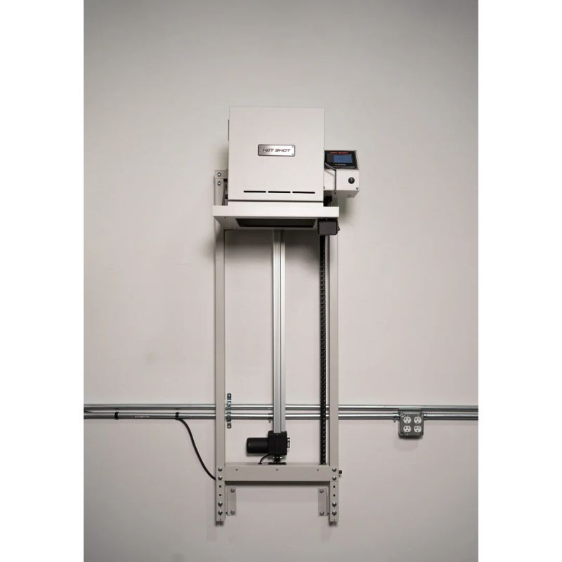 Straight on view of closed HS-7GV Vitrigraph Glass kiln from Hot Shot  placed on and raised up on Hot Shot's motorized VitriLift Electric Vitrigraph Lift - wallmounted in a studio.